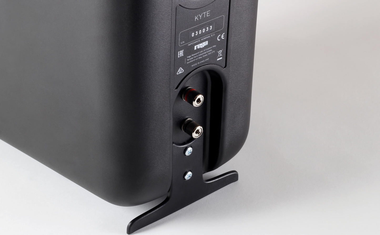 Product image for a Rega Kyte bookshelf speaker showing the rear panel with speaker plugs on.