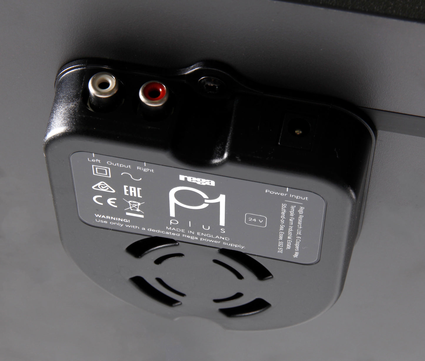Product image for the rear of a Rega Planar 1 Plus turntable in Matt Black finish showing the RCA output sockets and power socket.