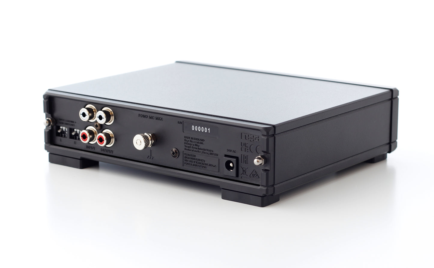 Product image of the rear panel of a Rega Fono MC Phono Stage showing the RCA input and output as well as the power input, dip switches and grounding pin.