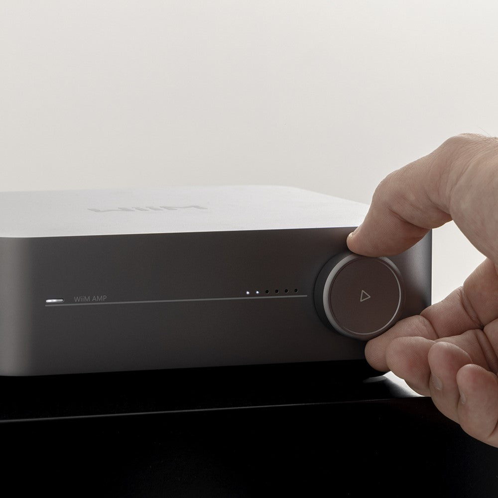 Lifestyle image of a WiiM Amp in Space Grey