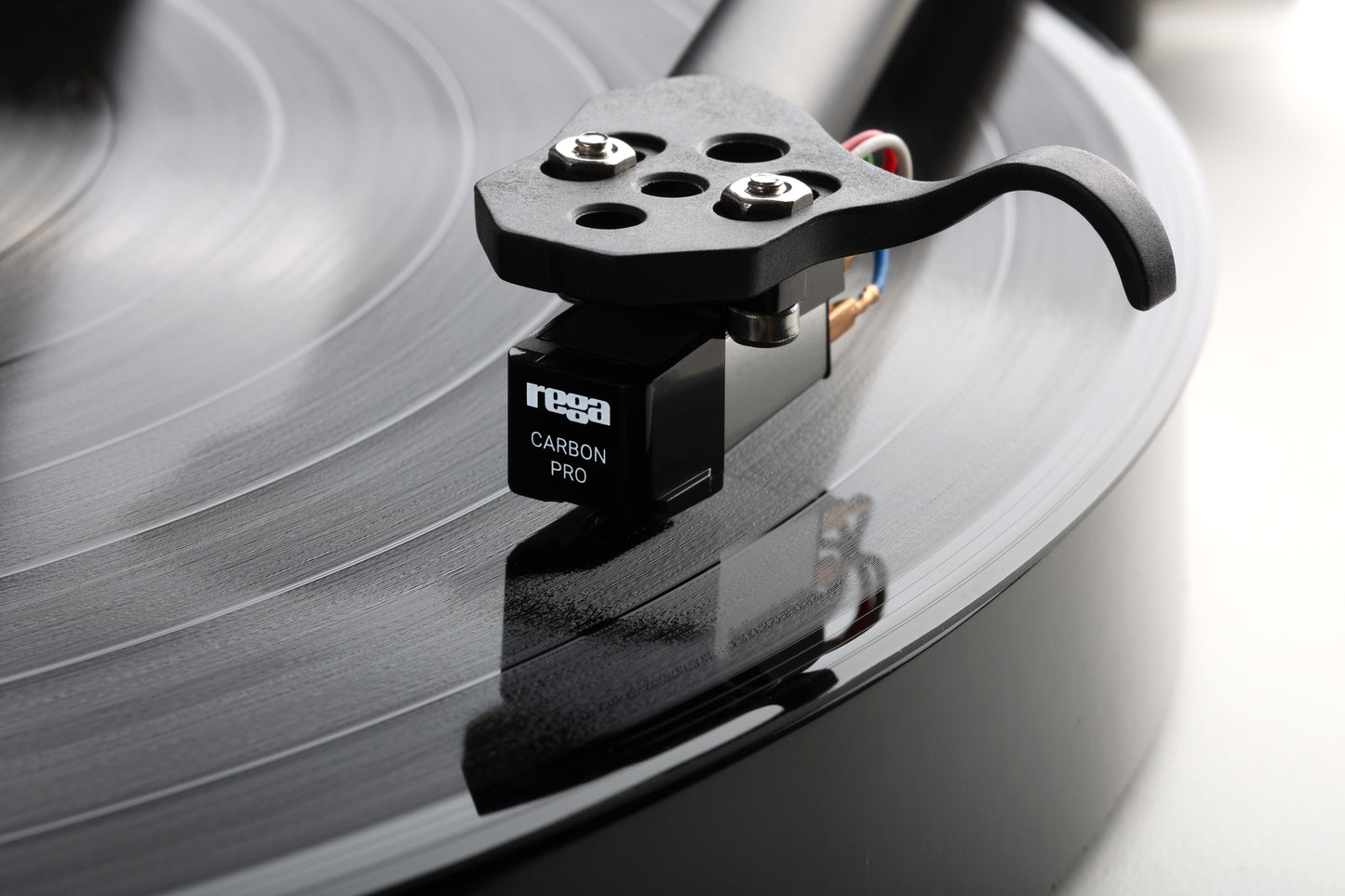 Product image of a Rega Carbon Pro Stylus playing a record.
