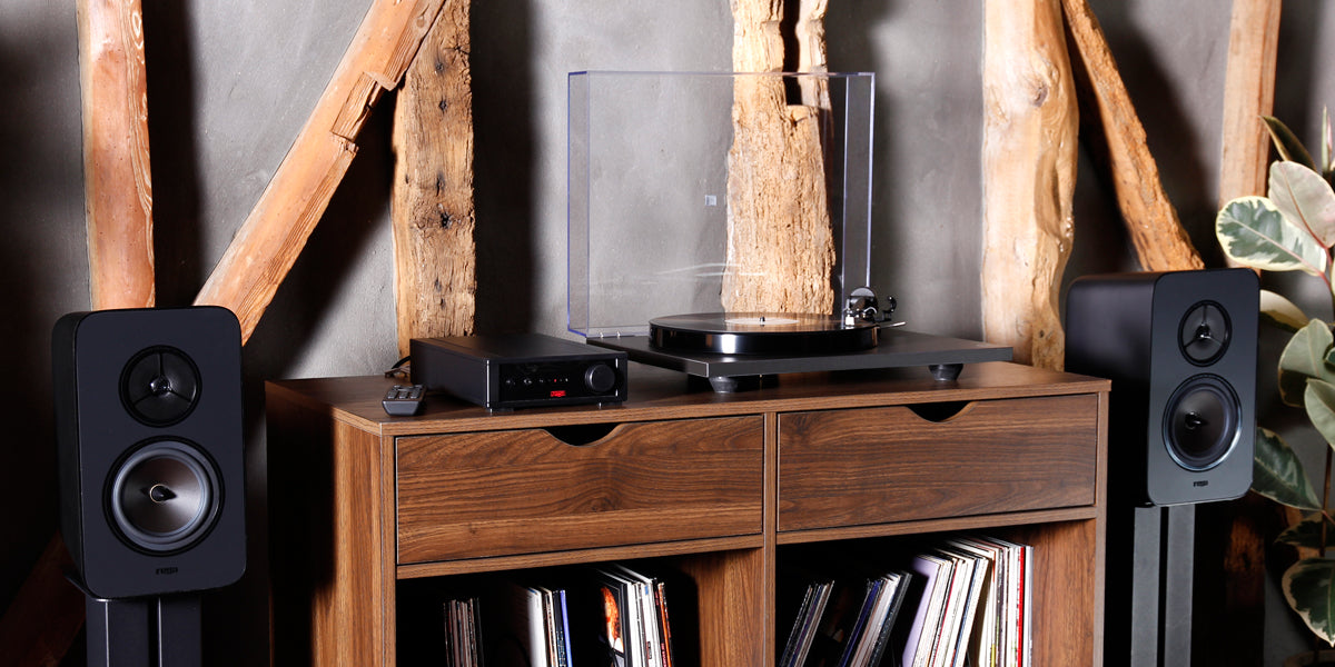 Lifestyle image for a Rega System One. Includes a pair of Rega Kyte speakers, Rega io amplifier and a Rega Planar 1 Turntable