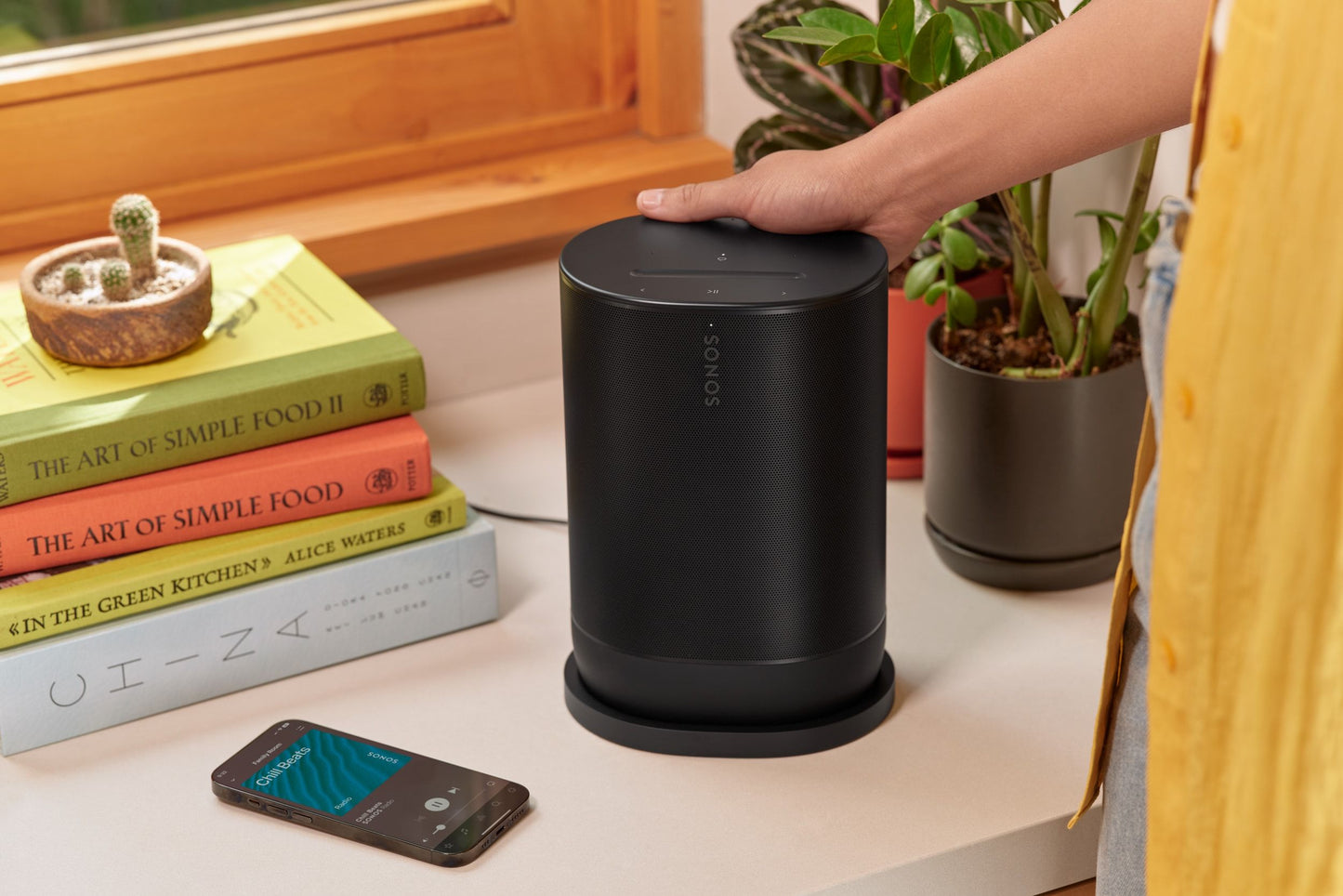 Lifestyle Image of a Sonos Move 2 portable speaker in black.