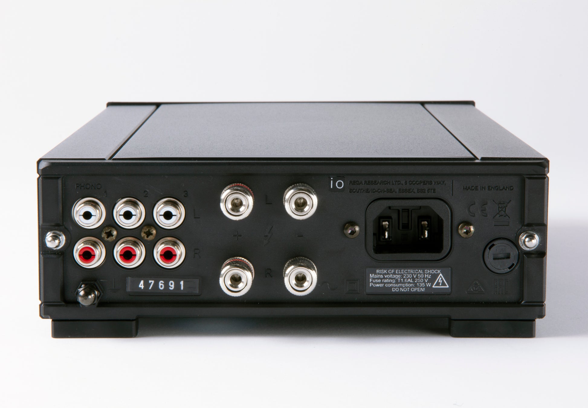Product image of the rear connection panel of a Rega io integrated amplifier featuring 3 pairs of RCA inputs, two pairs of banana speaker outputs and the power socket.