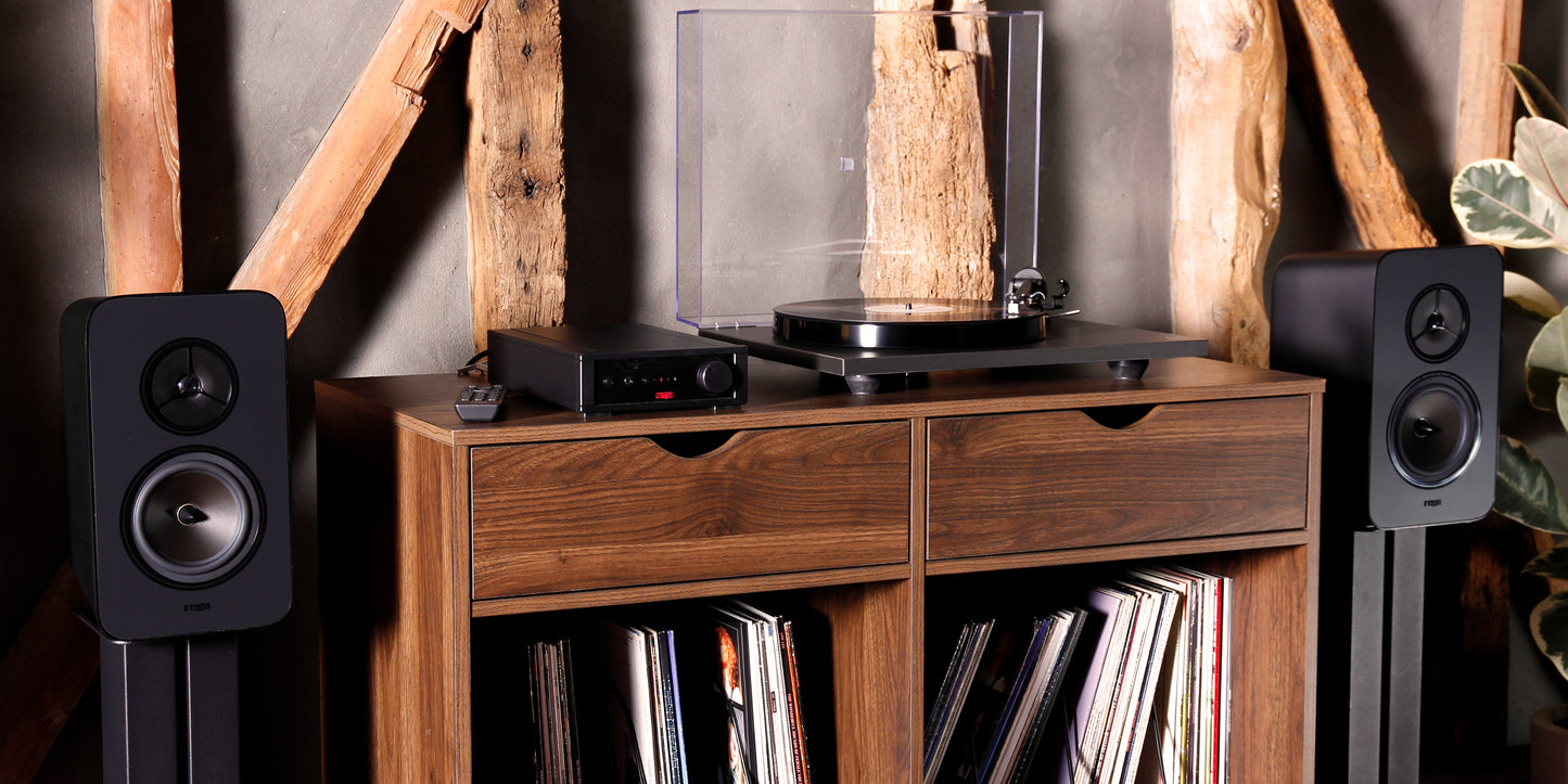 Product lifestyle Image of a Rega System One turntable package featuring a Rega Planar 1 turntable, Rega io Integrated Amplifier and a pair of Rega Kyte Speakers.