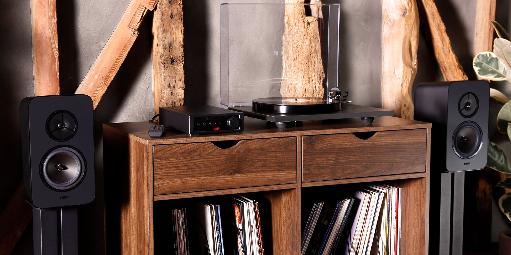 Product lifestyle Image of a Rega System One turntable package featuring a Rega Planar 1 turntable, Rega io Integrated Amplifier and a pair of Rega Kyte Speakers.