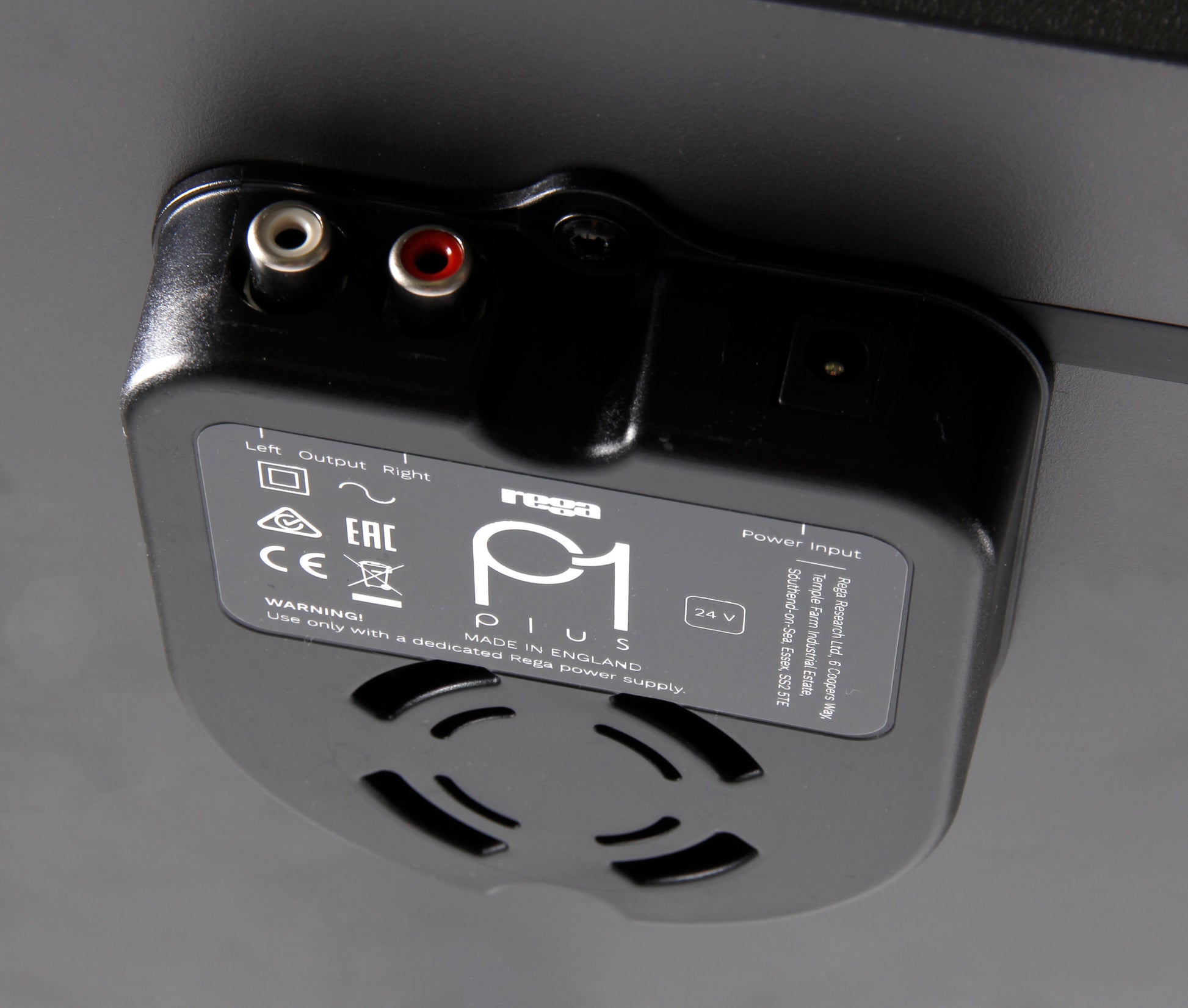 Product image for the rear of a Rega Planar 1 Plus turntable in Matt Black finish showing the RCA output sockets and power socket.