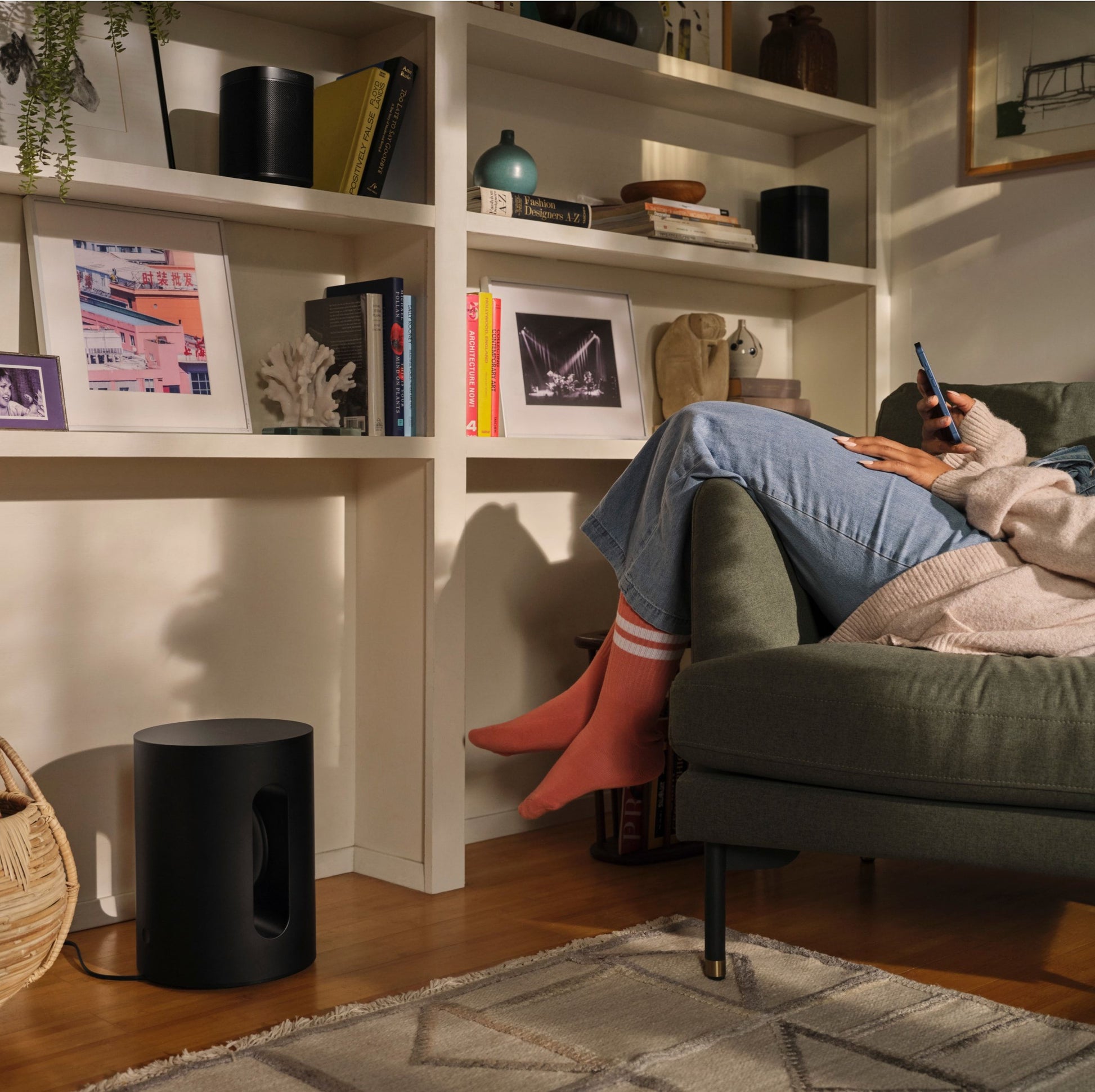 Lifestyle image of a Sonos Sub Mini Wireless Subwoofer in Black.