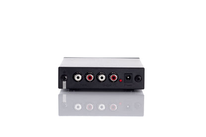 Product image of the rear of a Rega Fono Mini Moving Magnet Phono Stage / Pre Amplifier showing the RCA inputs and outputs and power socket